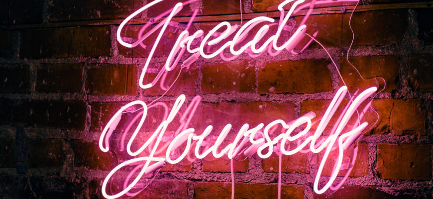 Pink,Neon,Treat,Yourself,Sign,On,Brick,Wall